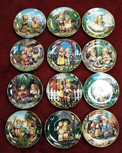12 Hummel plates from Danbury Mint: 12 Hummel plates from Danbury mint with COA's trimmed in 23k gold. Surprise,Little Musicians,Squeaky Clean,Private Parade,Apple Treee Boy and Girl,Stormy Weather,Tender Loving Care,LittleCompanions,Co