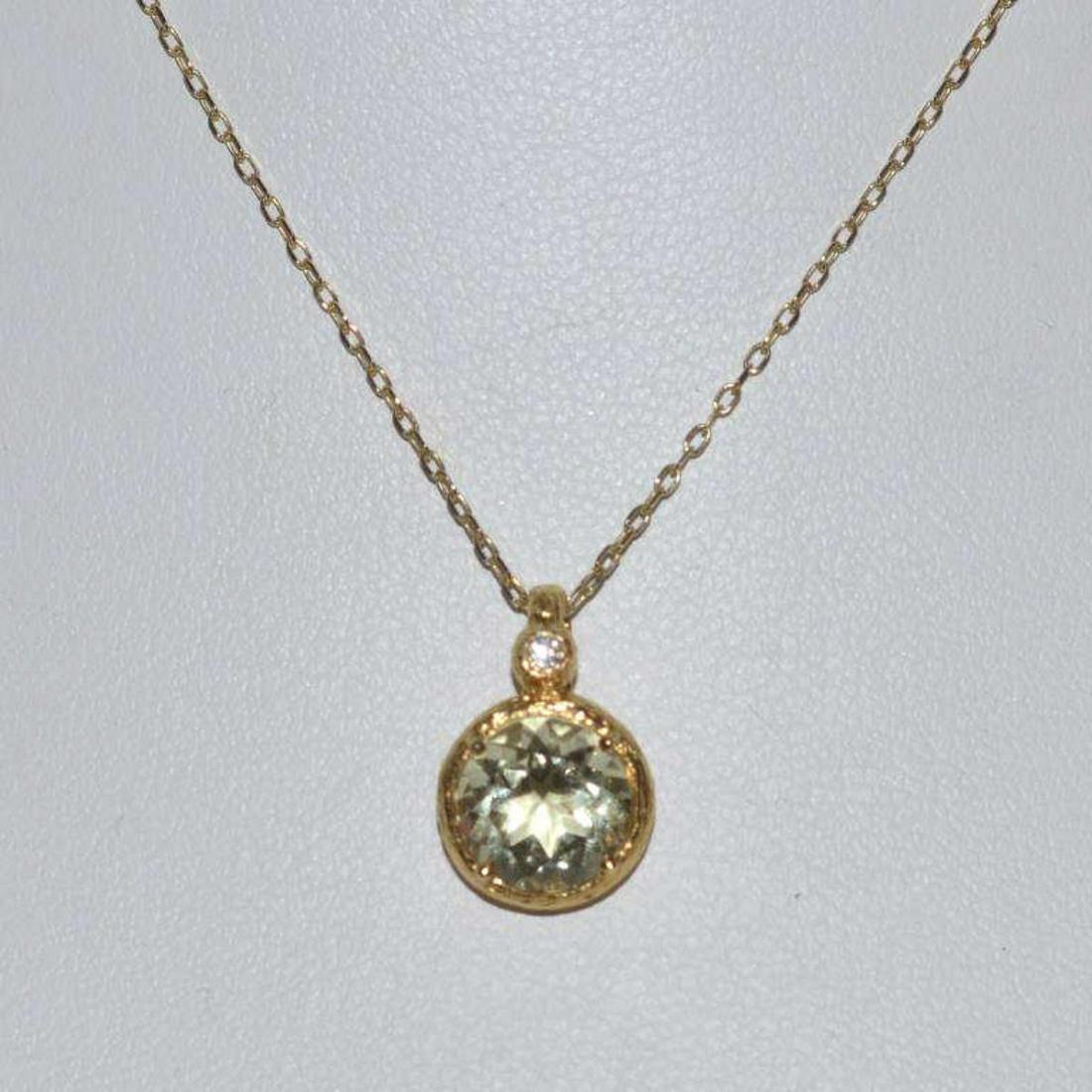 14kt yellow gold lemon quartz necklace: Ladies 14kt yellow gold lemon quartz necklace by designer Cheri Dori featuring a round bezel set cut lemon quartz accented by a bezel set round brilliant cut diamond weighing .02ct. on the bail. Bark 