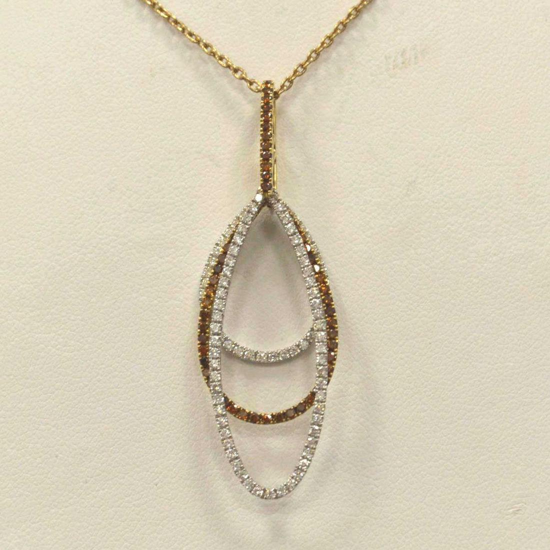 Ladies 18kt Two Tone Stacked Pendant: Ladies 18kt white and rose gold diamond pendant, featuring three oblong stacked rings. Center drop containing prong set round cherry diamonds while outer drops contain prong set round brilliant white