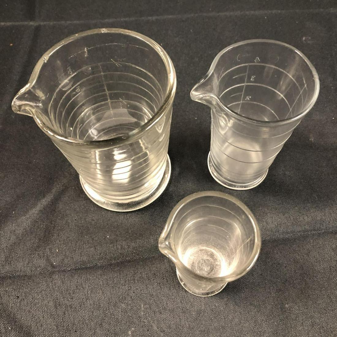 Lot Of Vintage Nesting Glass Measuring Cups: Lot Of Vintage Nesting Glass Measuring Cups. Comes 3 cups in set.