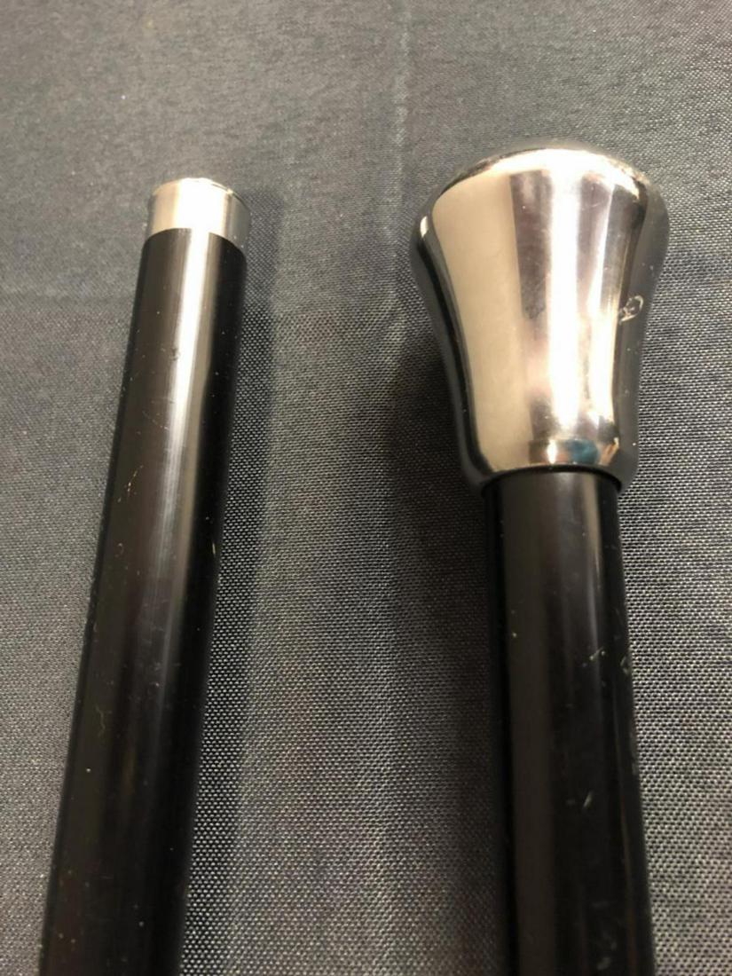 Walking Cane with Hidden Sword: Walking Cane W/Hidden Sword. Black cane with silver tip handle. Has push release button. Stands 37 1/2" tall.