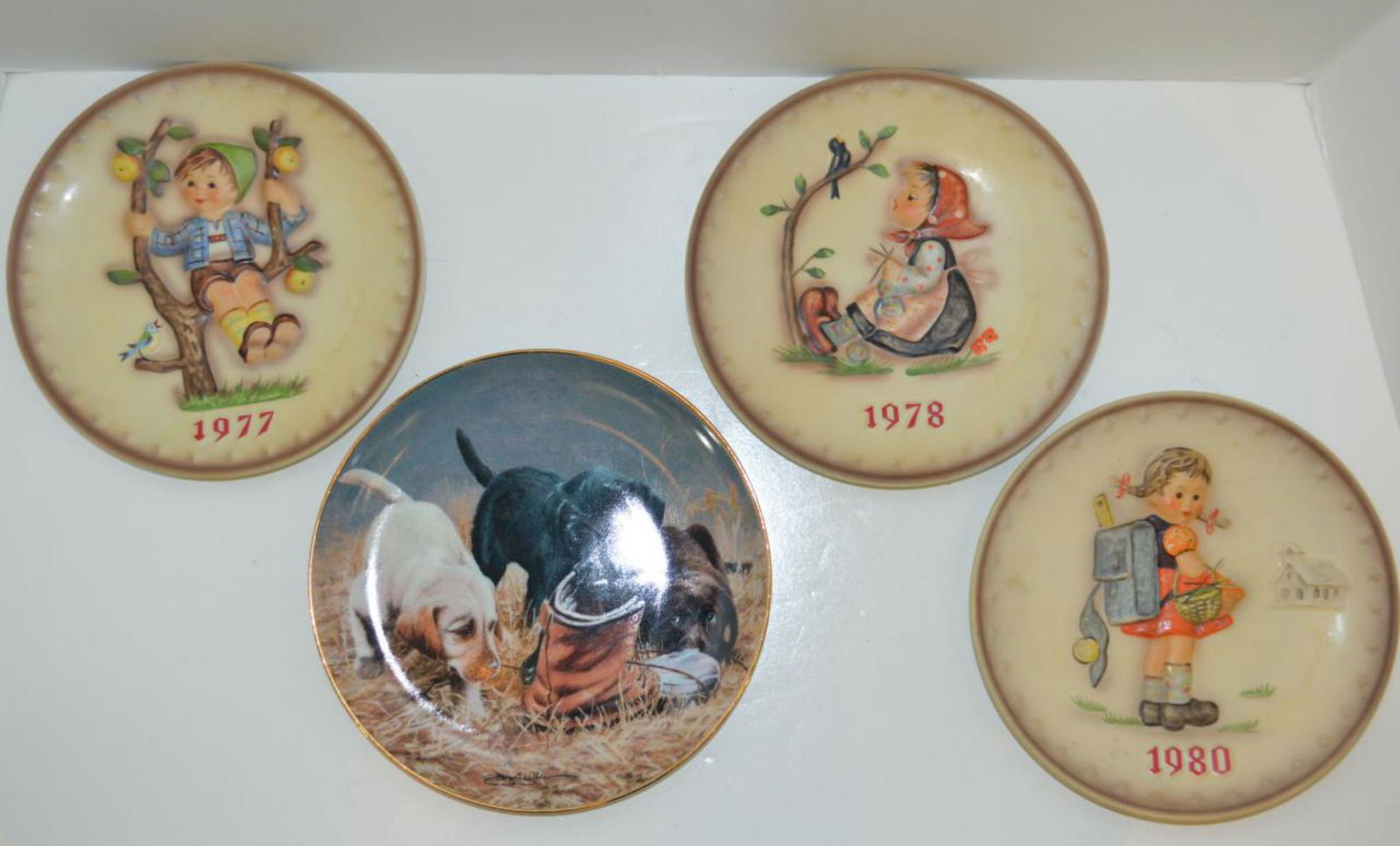 Four Collector Plates: Four Collector Plates. A Franklin Mint plate, "Three To Boot", 8"dia., together with three annual Hummel plates from 1977, 1978 and 1980, 7 1/2"dia.