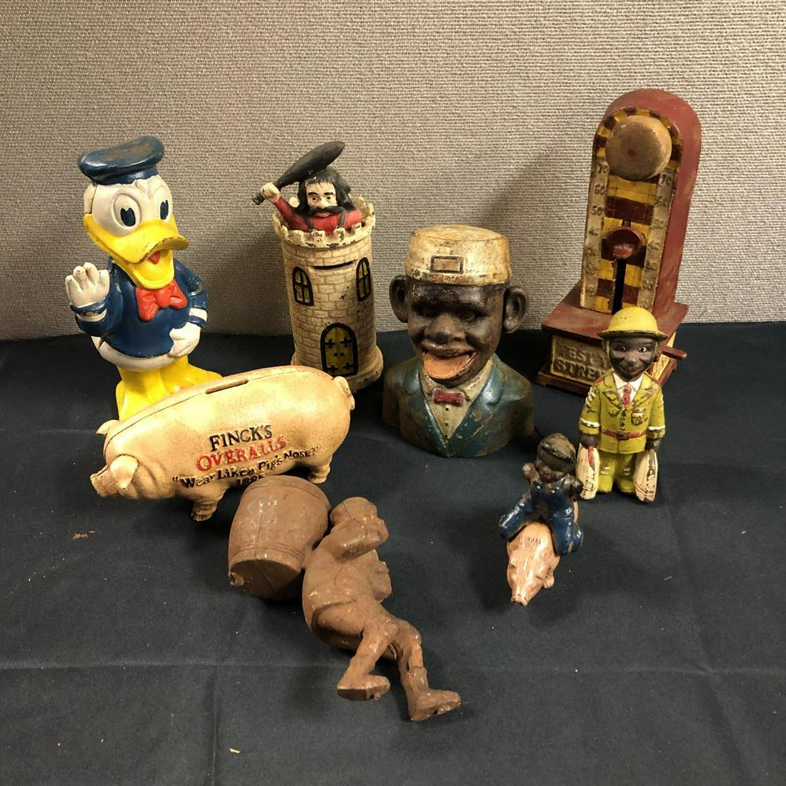 Lot Of Vintage Cast Iron Banks & Figurines: Lot Of Vintage Cast Iron Banks. 8 total in lot. Donald Duck, test your strength, boy riding a pig , finck's overalls "Wear Like A Pig's Nose" 1885 etc.