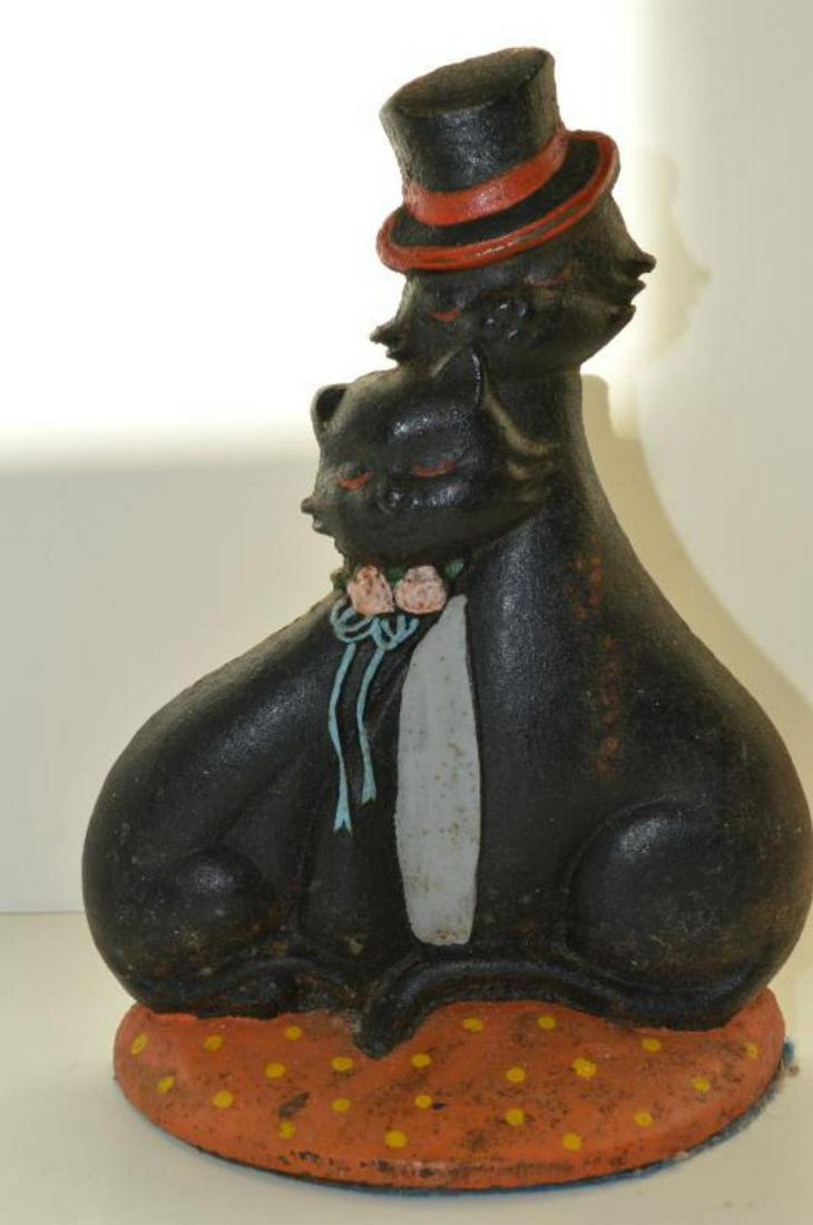 "Loving Cats" Cast Iron Doorstop Top Hat Cat: "Loving Cats" Cast Iron Doorstop Top Hat Cat. A great depiction of a pair of sweetheart cats. Felt covered bottom. Eyelet on reverse, 9 1/4" tall & 7" across. Painted surfaces.