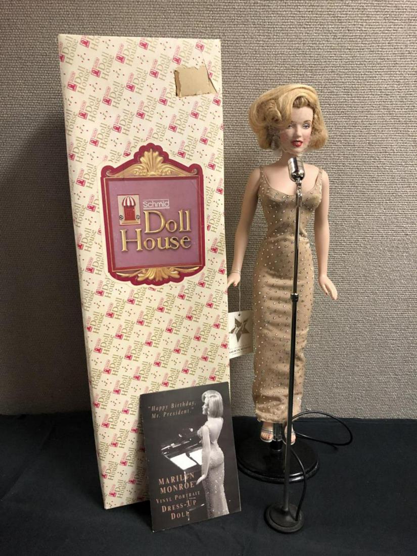 Marilyn Monroe Vinyl Portrait Dress Up Doll: Marilyn Monroe Vinyl Portrait Dress Up Doll. Schmid Doll House. Doll Measures 17" high. Comes with booklet "Happy Birthday Mr. President" . Doll has A Stand And a microphone to sing.