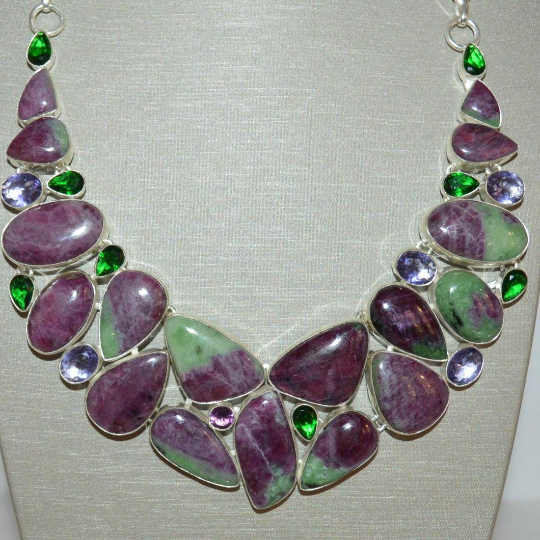 Ladies Sterling Sliver Ruby Zoisite Necklace: Ladies sterling silver ruby zoisite necklace featuring various shape bezel set polished ruby zoisite weighting approx. 387.5cttw. Accented with various bezel set gemstones. Length 18". Weight 118gr. T
