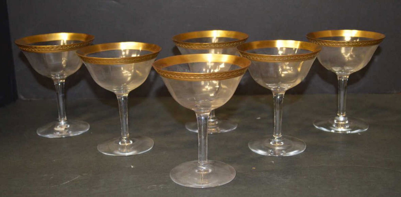 6 gold rimmed wine glasses: 6 wine glasses with wide gold floral rim. 4.5" tall. Has chips.