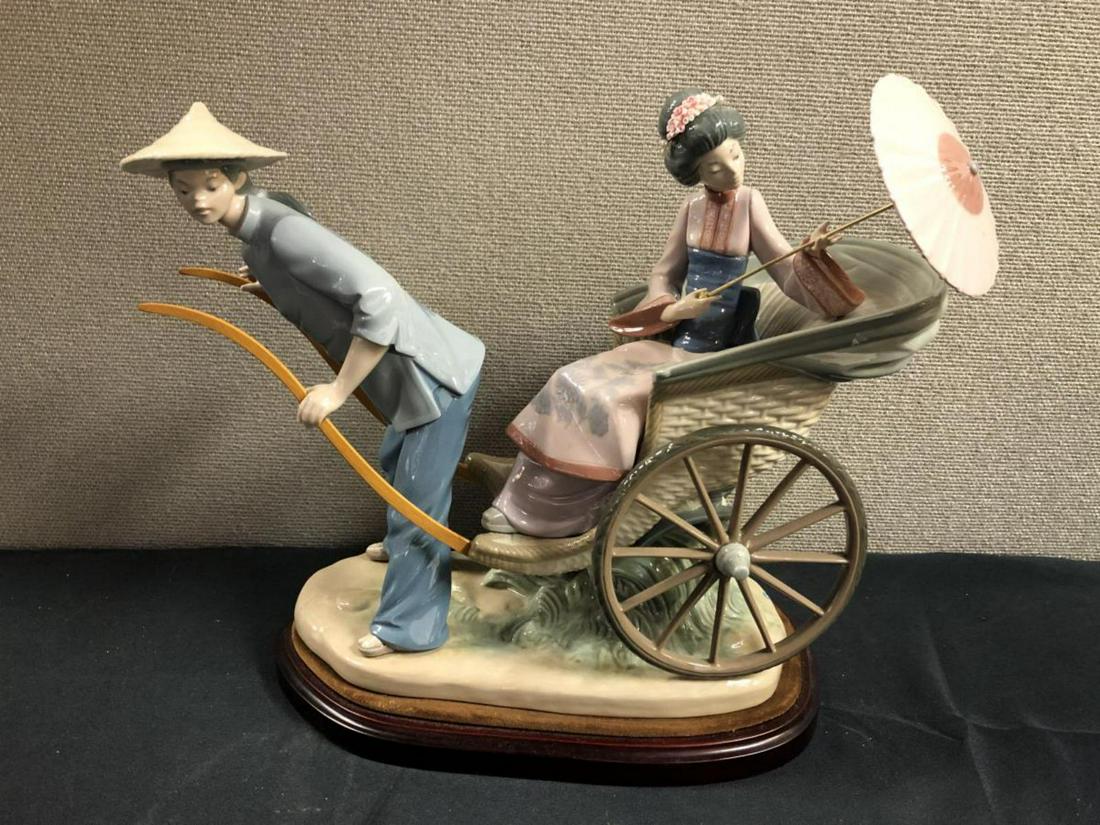 Vintage Retired Lladro Sculpture A Rickshaw Ride: Vintage Retired Lladro Sculpture#1383 Titled "A Rickshaw Ride" . A wonderful depiction of an elegant Asian woman with a pearl & floral headband. Her parasol is on a threaded removable brass pole. The 