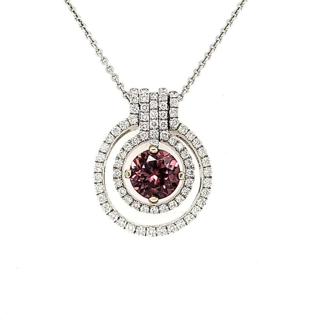 18kt Rose Zircon Halo Pendant: Ladies 18kt white gold double halo pendant with one round brilliant cut Rose Zircon measuring 6.9mm, approx. 1.80ct. surrounded by two circles of round brilliant cut diamonds weighing 0.59ct.. Chain l