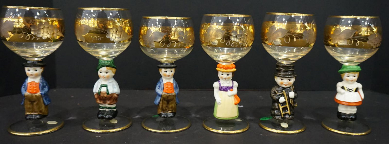 Set of 8 Vintage Glasses Goebel Hummel Figurines: Set of 8 Vintage Glasses Goebel Hummel Figurines. Wonderful great German crafted gold gilt glasses. Each goblet features a colorful child character for the stem section. A great set perfect for water,