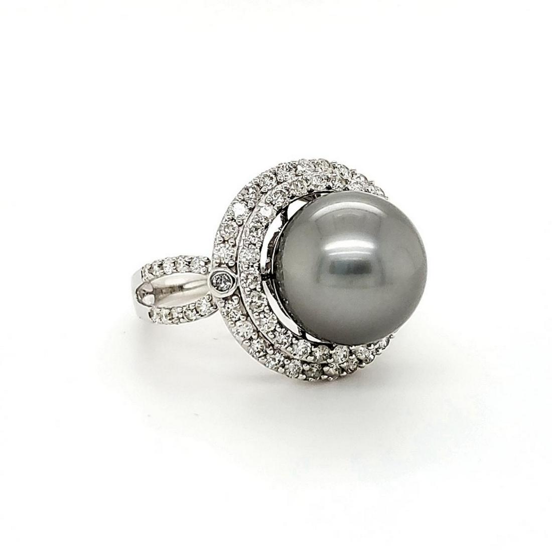 18kt white gold Tahitian pearl and diamond ring: Ladies 18kt white gold Tahitian pearl and diamond ring featuring a 12mm dark silver Tahitian pearl with good luster. Surrounded by a double halo and shoulders of prong set round brilliant cut diamonds