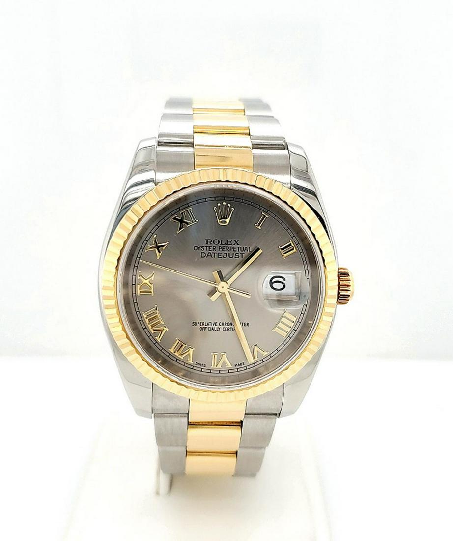 Men's two tone Rolex Datejust watch: Men's two tone Rolex Datejust watch, model #116233, year 2003 3/4, featuring a two tone oyster bracelet, fluted bezel, silver Roman numeral dial, automatic self-winding movement, and sapphire crystal.