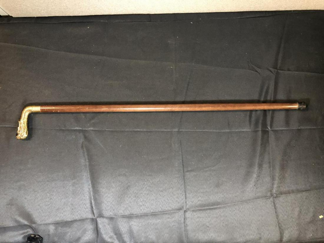 Vintage Dragon Head Sword Cane Walking Stick: Vintage Dragon Head Sword Cane Walking Stick. The brass Dragon Head handle screws off to reveal a blade sword. The bottom tip is brass but has a rubber covering to it (can be easily removed). Measures