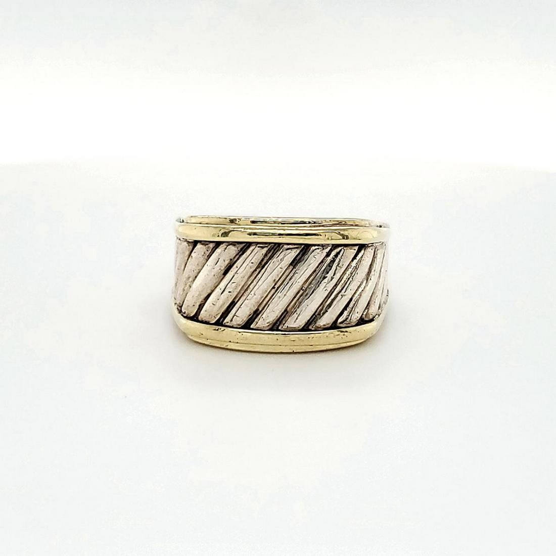 David Yurman sterling and 14kt "Thoroughbred" ring: Ladies David Yurman 14kt yellow gold and sterling silver "Thoroughbred" ring featuring a textured cable design and ridged yellow gold detail. Measures 12mm wide. Finger size 8.5. Weight 0.40 ozt.