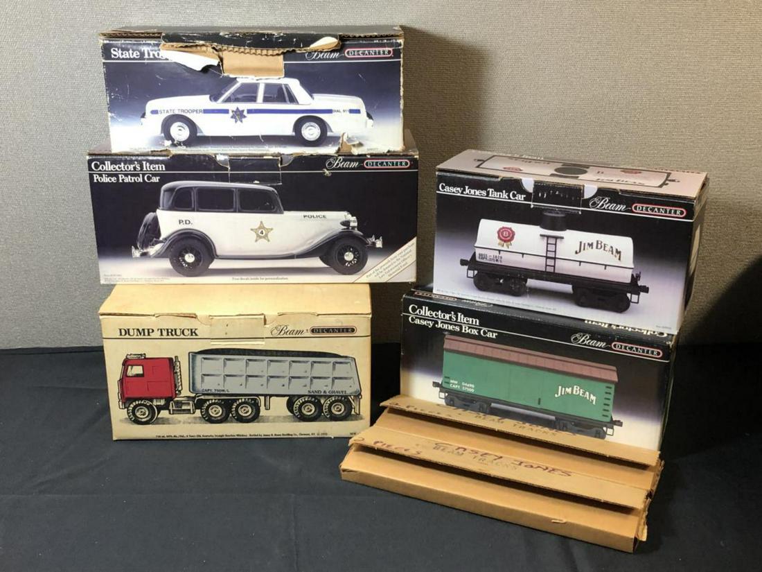 Lot Of Jim Beam Collector's Item Decanters: Lot Of Jim Beam Collector's Item Decanters. Total of 5 in the lot. Consists of 2 Casey Jones Tank Car. Dump Truck. State Trooper. Police Patrol Car. Some full with unknown liquid.