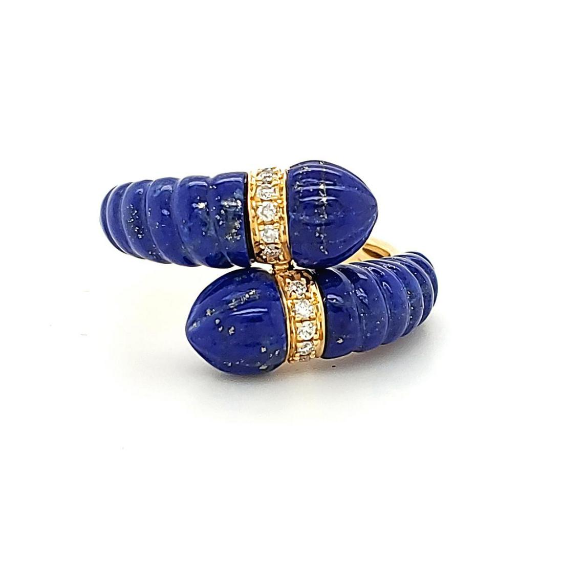 18kt yellow gold lapis lazuli and diamond ring: Ladies 18kt yellow gold lapis laziuli and diamond ring featuring carved lapis lazuli weighing approx. 10.48ct. and mounted in a bypass design. Accented with prong set round diamonds weighing approx. 0