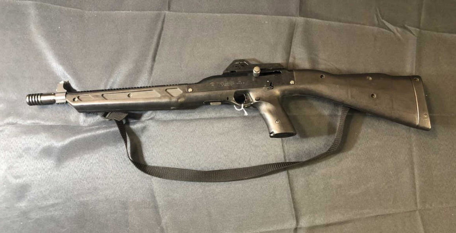Hi-Point Model 995 Nylon 9mm Rifle with Magazine: Hi-Point Model 995 Nylon 9mm Rifle with Magazine. This compact semi-automatic rifle features a 16 1/2" barrel with a muzzle brake or flash suppressor attached. Nylon strap. Serial #A74889. Adjustable 