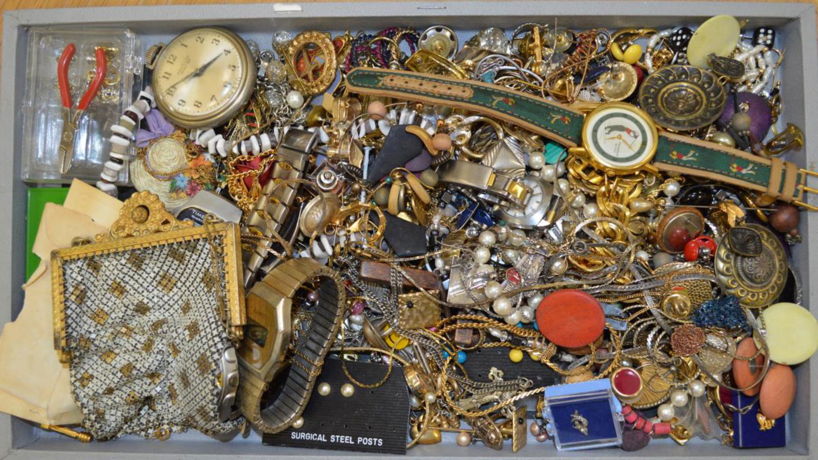 Large lot of costume jewelry: Large lot of costume jewelry including various watches, cufflinks, fancy link bracelets, chains, button covers, earrings, small metal purse and more.