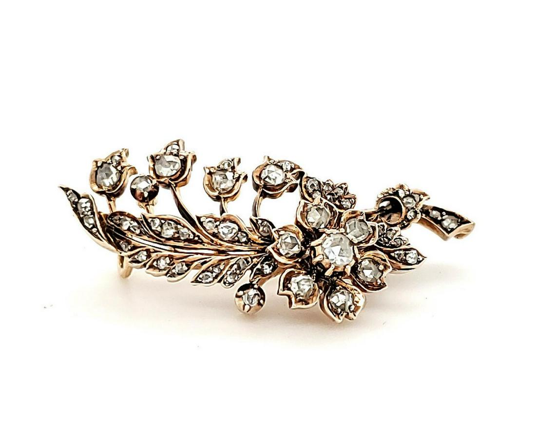 14kt yellow gold diamond rose brooch.: Ladies 14kt rose gold brooch containing prong set round rose cut diamonds weighing approx. 0.92ct., Clarity I1-I2, Color I-J. Mounting in a flowing floral design. Piece measures 1.5 x ¾”m. Weight 9