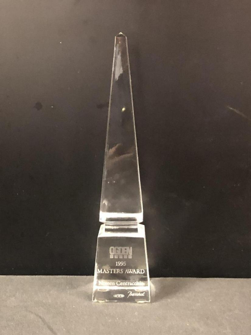 Baccarat Crystal Pyramid Obelisk Sculpture: Baccarat Crystal Pyramid Sculpture. Stands 10" tall. Ogden 1995 Masters Award Noreen Centracchio printed on the from of the sculpture. Baccarat etching on the bottom of the pyramid.