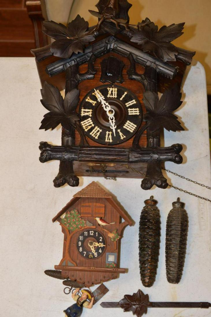 Pair Of Cuckoo Clocks: Pair Of Cuckoo Clocks. They may or may not work. Small one is wintermantel. Made in West Germany. Stands 8 1/2" tall. Girl on a swing at the bottom. Second clock as Deer in the woods. Stands 16 1/2" t