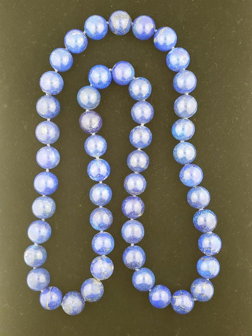 Continuous strand of lapis lazuli beads: Continuous strand of lapis lazuli beads containing single knotted lapis lazuli beads measuring 15.5 – 16mm. Length 31”.(93)