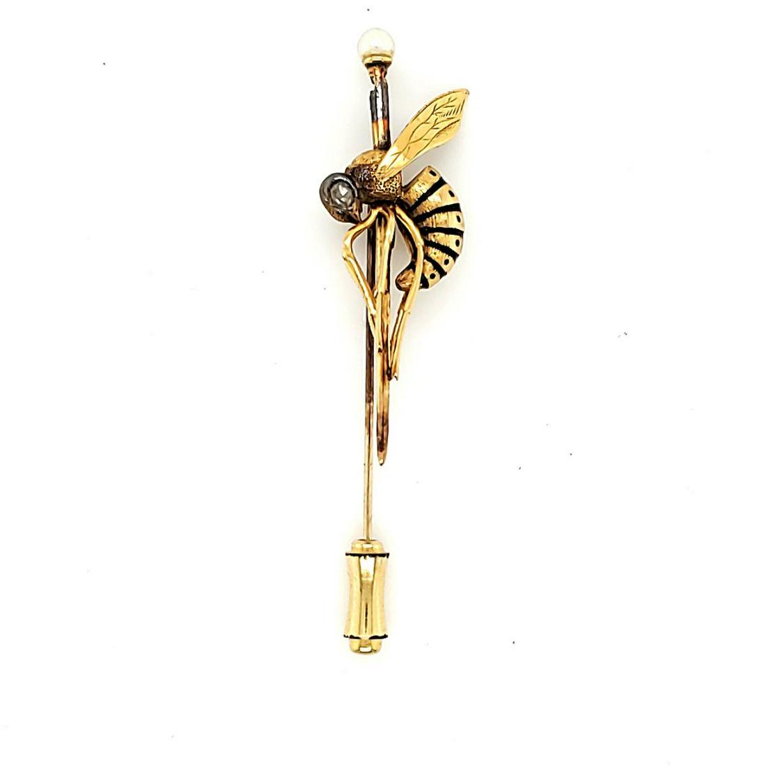 18kt yellow gold hornet stick pin: 18kt yellow gold hornet stick pin featuring the body of a hornet accented with two bezel set rose cut diamonds weighing approx. .10ct., Clarity I1-I2, Color L. The body is detailed with black enamelin