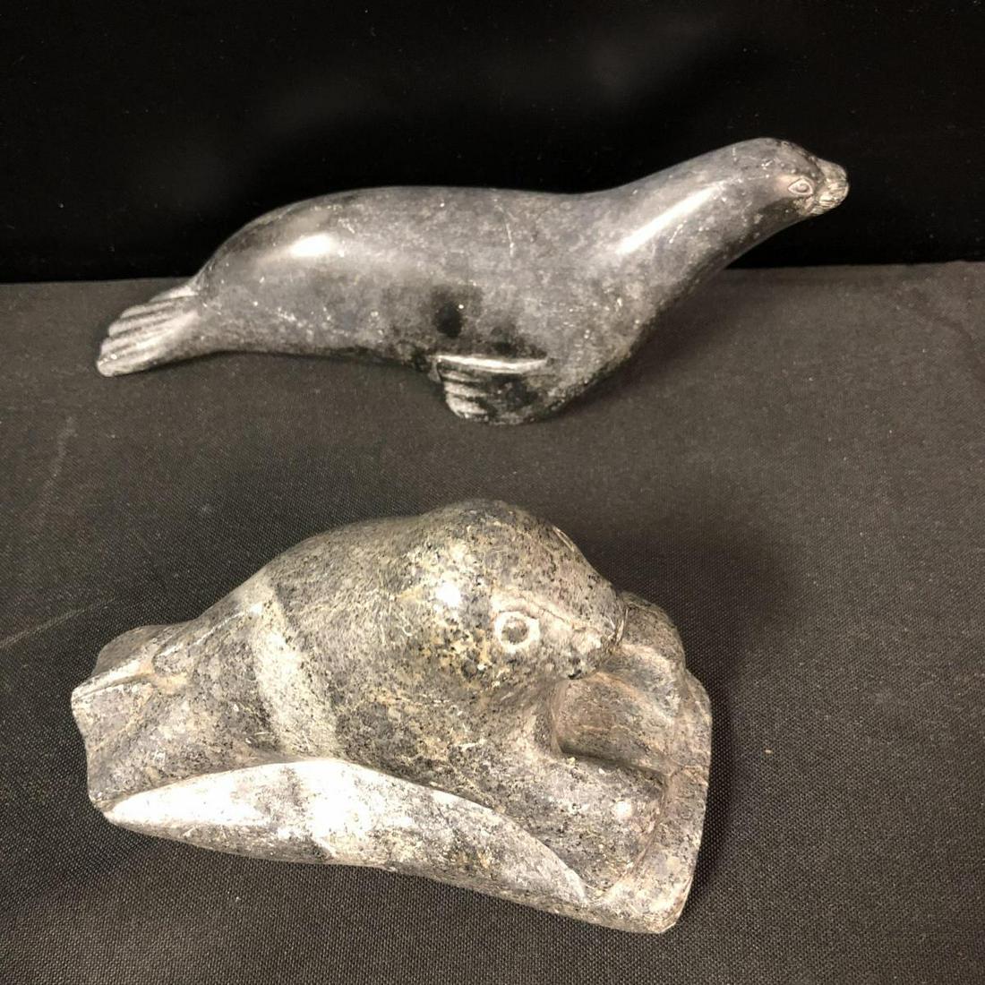 Soapstone Stone Seal Statues: Soapstone Stone Seal Statues. Two seal statues in the lot. First seal stands 3 1/2" tall and measures 5 1/2" across. Second seal stands 2 1/4" tall and measures 8" across. Both seals have numbers on t