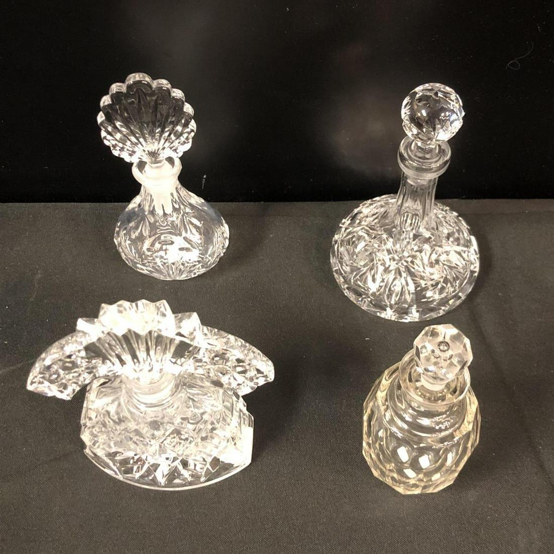 Group Four Vintage Crystal Glass Perfume Bottles: Group of Four Vintage Crystal & Glass Perfume Bottles with Stoppers. Oval or cylinder shaped faceted 5" tall with bubble embedded stopper, exhibits chips on bottom. Bulbous body with narrow neck 6" ta