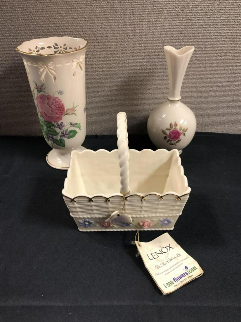 Trio Of Lenox Porcelain Basket & Vases: Lot Of Lenox Porcelain. Total of 3 pieces in the lot. Consists Of Hand Decorated w/24k Gold Vase standing 8" tall. Lenox Basket Of Blooms standing 7" tall. Lenox Floral Vase standing 8 1/2" tall.