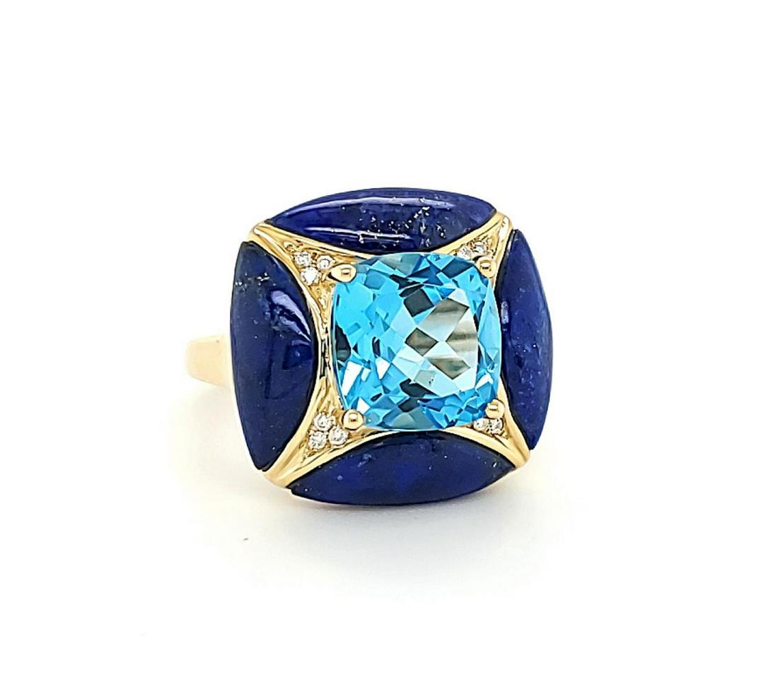 14kt yellow gold blue topaz and lapis lazuli ring: Ladies 14kt yellow gold blue topaz and lapis ring featuring a prong set cushion cut swiss blue topaz weighing approx. 5.61ct.. Accented with lapis lazuli weighing approx. 5.16ct and round brilliant cu