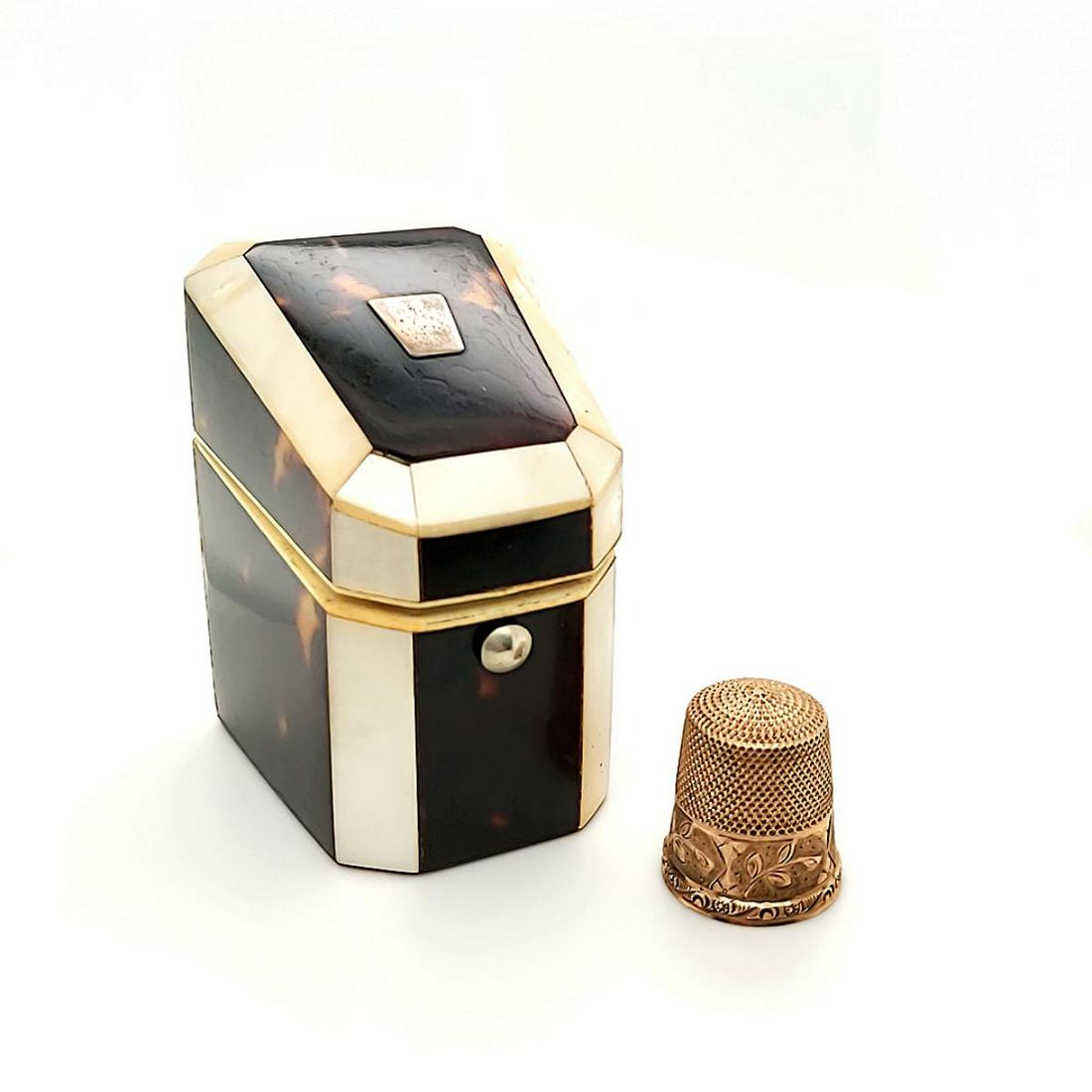 10kt yellow gold thimble with fitted box: 10kt yellow gold thimble with engraved floral pattern and personalized name. Thimble fit into a fitted box accented with mother of pearl and tortoise pattern panels. Missing piece of mother of pearl s