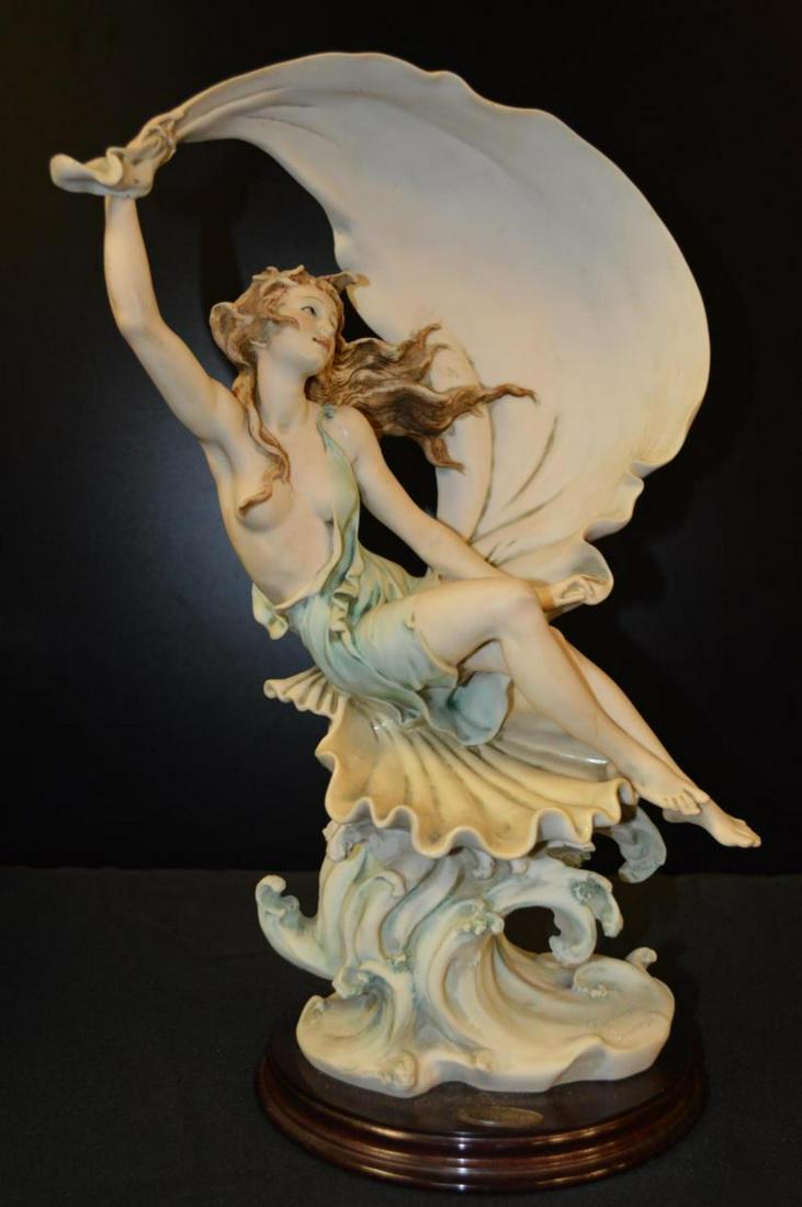 Wind Song-Girl With Scarf: "Wind Song-Girl With Scarf". Guiseppe Armani Figurine. Stands 16 1/2' tall. Figurine sits on a wood base. Artist name on the bottom of the figurine as well as on the wood base. on the back of the figu