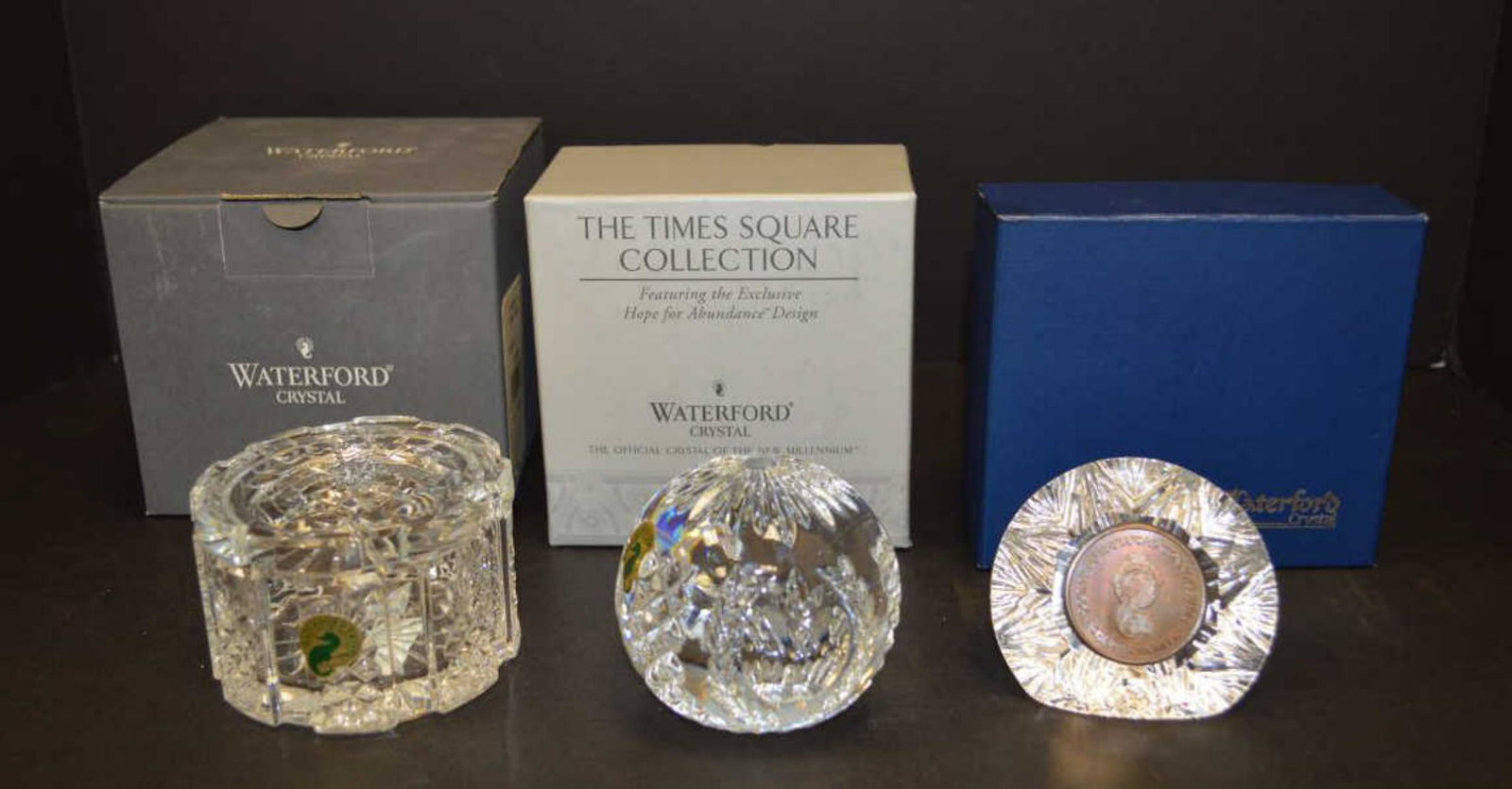 Three Items of Waterford Crystal w/Original Boxes: 3 pieces of Waterford crystal, one Dorset desk box with original box, one 2001 Time Square ball paperweight signed by Fred Curtis in original box, and one "Society of Waterford Connoisseurs" paperweig