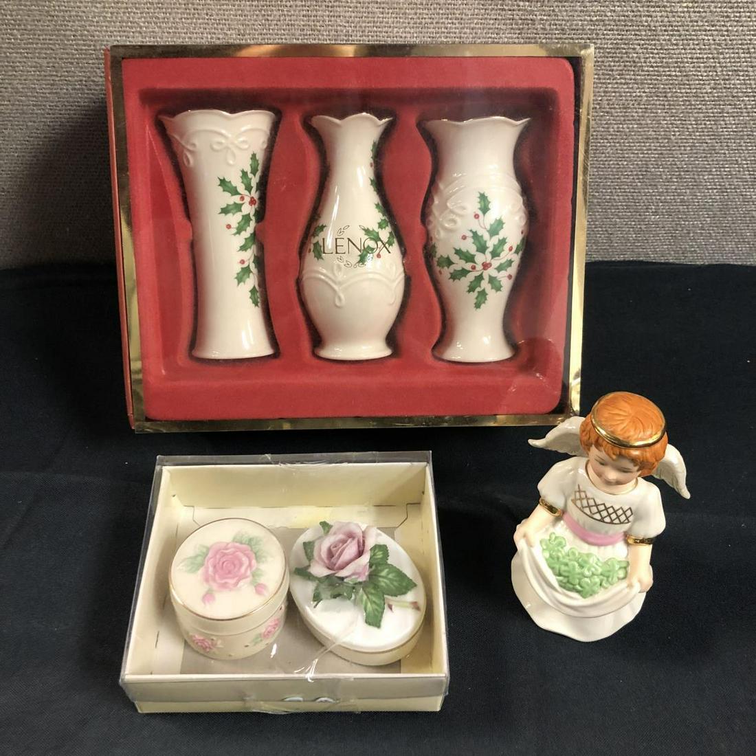 Lot Of Lenox Pieces Vases Angel Trinket Boxes: Set Of Lenox Pieces. Consists of Lenox Shamrock Smiles standing 5 1/2" tall. Set Of 3 Lenox Holiday Bud Vases SKU#6435499. Comes in the box. Pair Of Lenox The Rose(Genus Rosa)Fine Porcelain. Comes in 