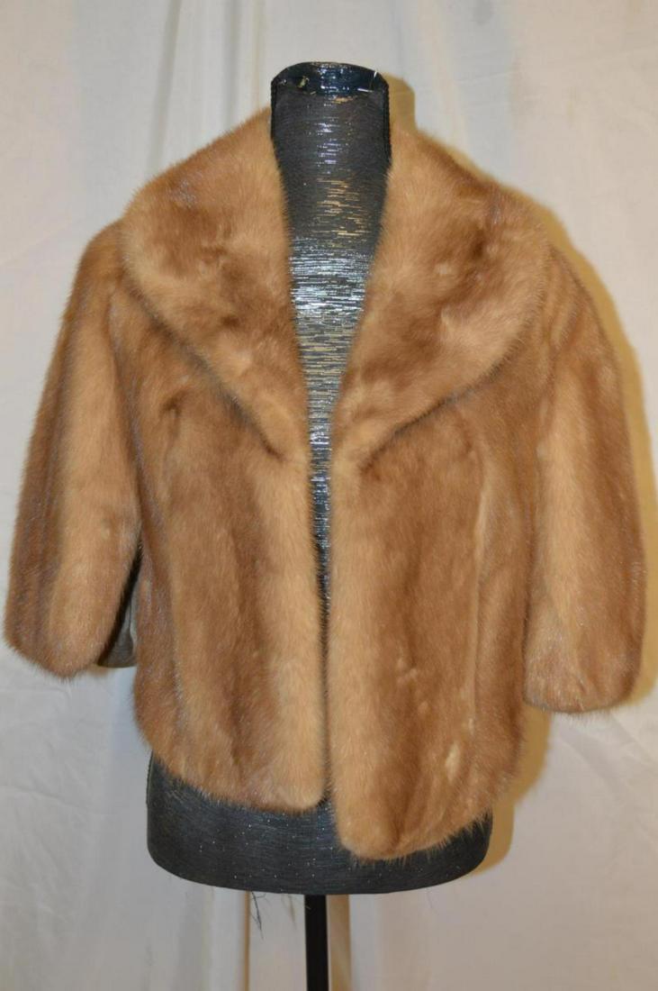 Ladies Vintage Caramel Colored Mink Cape: Ladies Vintage Caramel Colored Mink Cape. This great cape has two front breast pockets, it is fully lined with a turn-up collar. Vertically striped. It is an approx. size medium. It is 20" from should