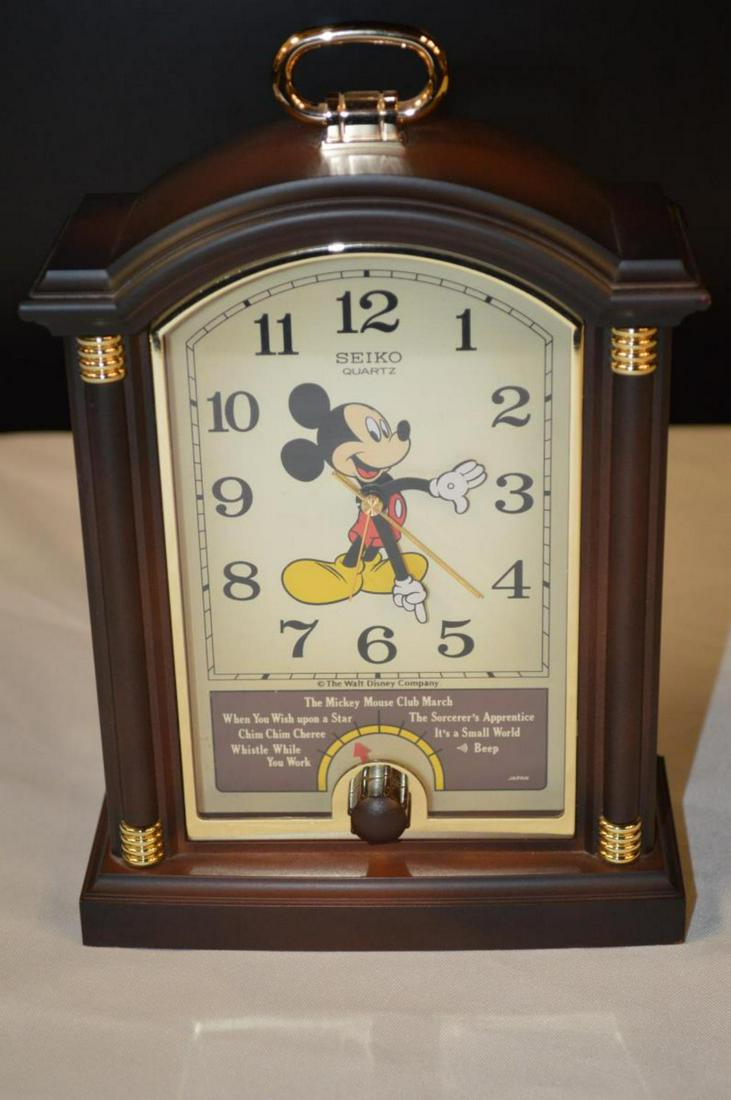 Seiko Mickey Mouse Theme Mantle Clock: Musical clock in a composite case with Mickey's arms serving as the hands, 9"h., with original box.
