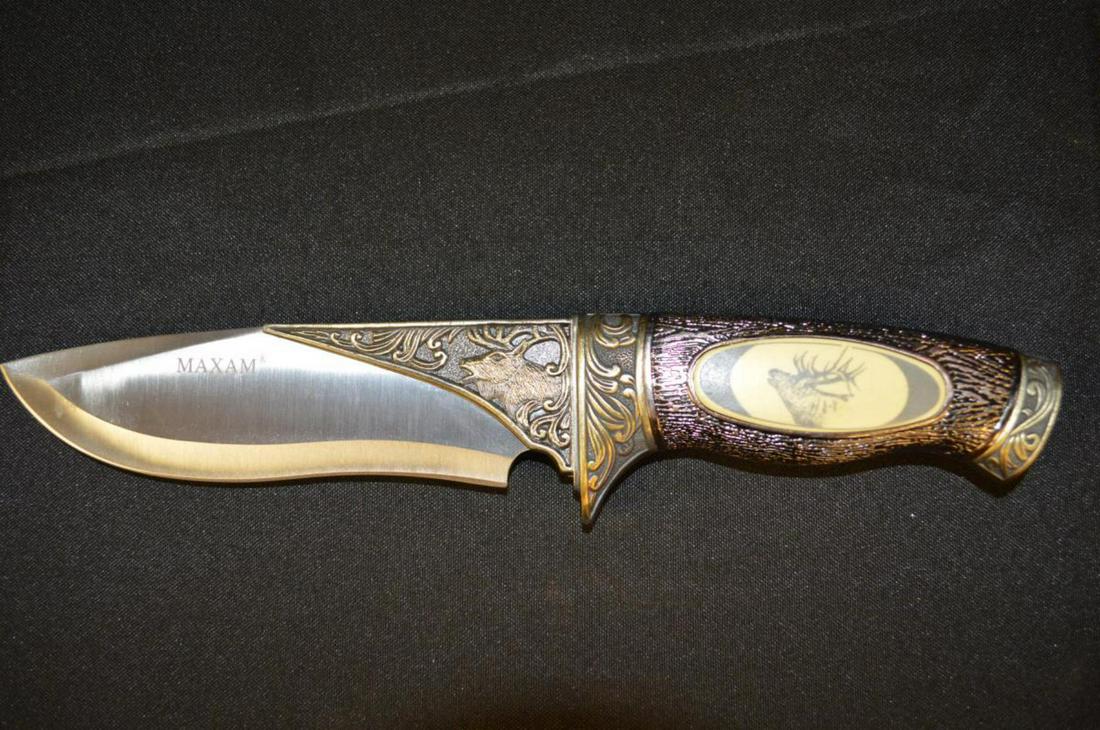Maxam Large Elk Theme Buck Type Knife in Box: Maxam Large Elk Theme Buck Type Knife in Box. Brass tone textured handle with elk inset. 11" overall in wood present box.