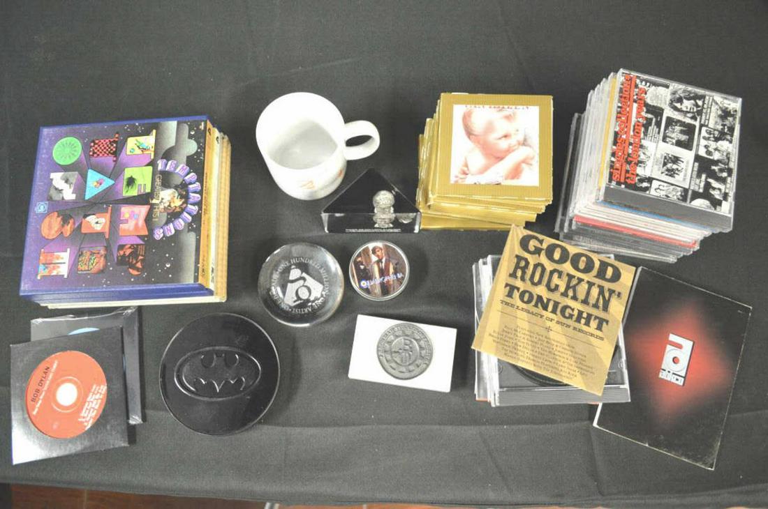Lot Of Musical Memorabilia Collectibles: Lot Of Musicial Memorabilia Collectibles. Consists Batman soundtrack CD. Pink Floyd "A Momentary Lapse Of Reason" coffee cup. Michael Jackson thriller over 35 million albums paperweight. One artist, O
