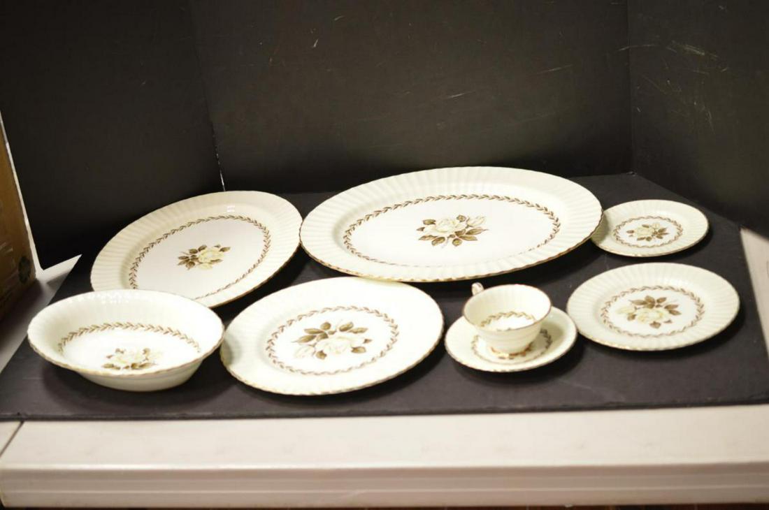 Paragon Fine Bone China in the Melanie Rose Pat.: A Set of Paragon Fine Bone China in the Melanie Rose Pattern. A cream or ivory colored body with gold trimmed scalloped edges & yellow rose pattern. The set includes 12-Dinner plates 10 7/8", 9-Salad 