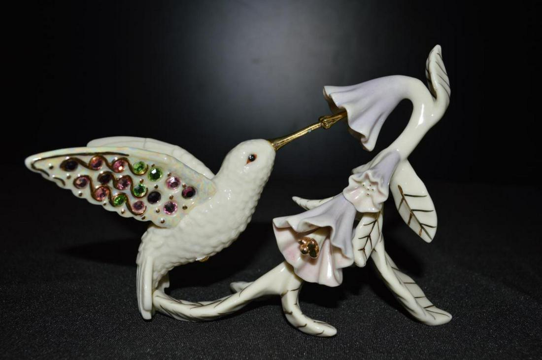Lenox Garden's Brilliance: Lenox Garden's Brilliance. Comes with box. Lenox hummingbird by a flower.