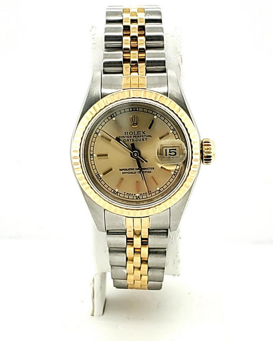 Ladies two tone Rolex Datejust watch: Ladies two tone 18kt and stainless steel Rolex Datejust watch, model #69173, featuring a champagne color dial with stick markers, fluted bezel, jubilee bracelet, sapphire crystal and automatic movemen