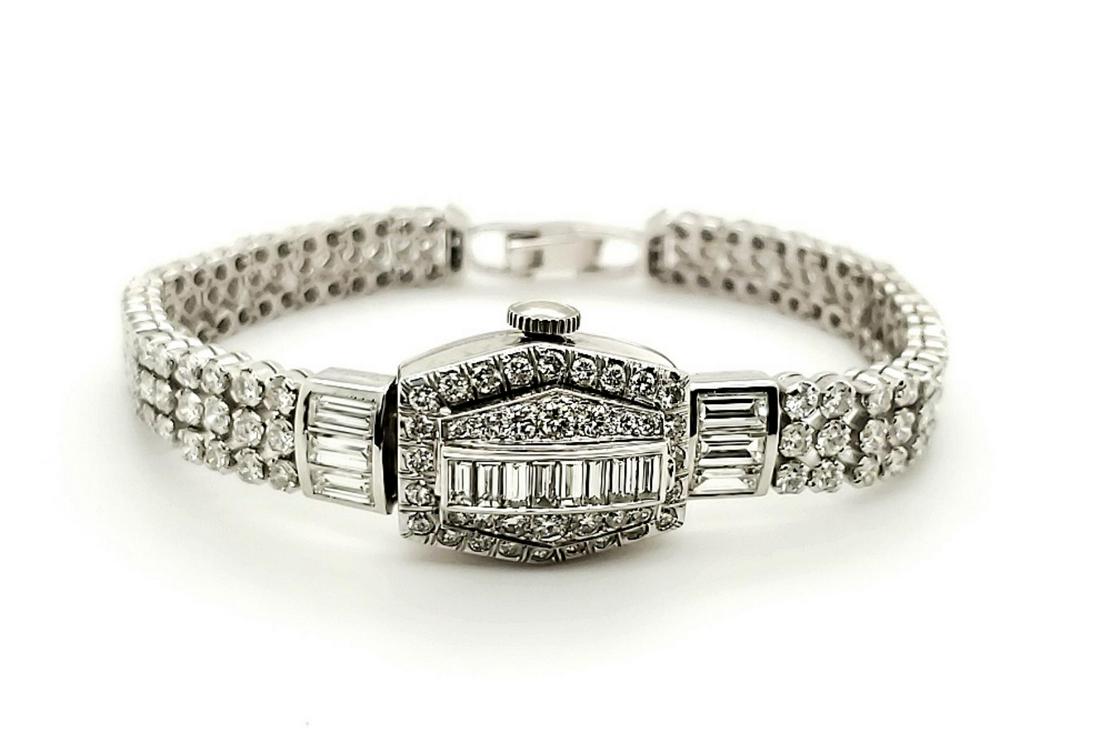 Platinum and diamond dress watch: Ladies platinum and diamond dress watch with cover top featuring prong set baguette and round brilliant cut diamonds weighing approx. 7.55ct., Clarity VS1-SI2, Color G-H.. Containing a Hamilton 22 jew