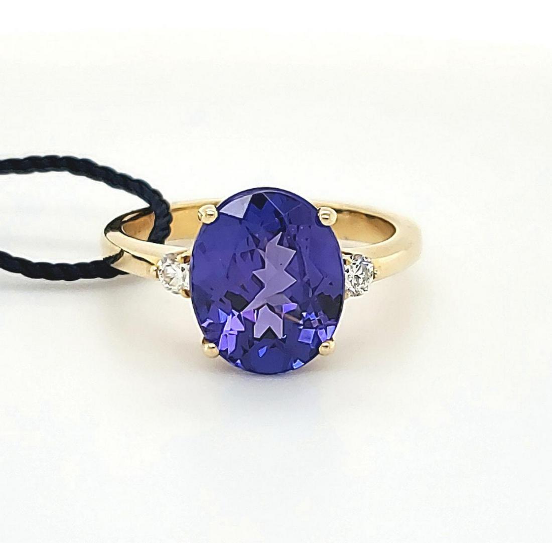 14kt yellow gold tanzanite and diamond ring: Ladies 14kt yellow gold tanzanite and diamond ring featuring a prong set oval cut tanzanite weighing approx. 3.77ct.. Accented with prong set round brilliant cut diamonds weighing approx. 0.13ct. Fing