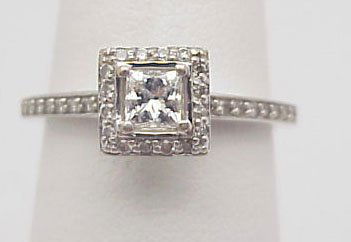 Vintage style Diamond Engagement Ring: 14K white gold lady's vintage style diamond engagement ring 2.65 grams. There is one princess cut, four prong set, center diamond, approx. .22 cts, I-J, SI3 and 32 single cut accent diamonds, approx.