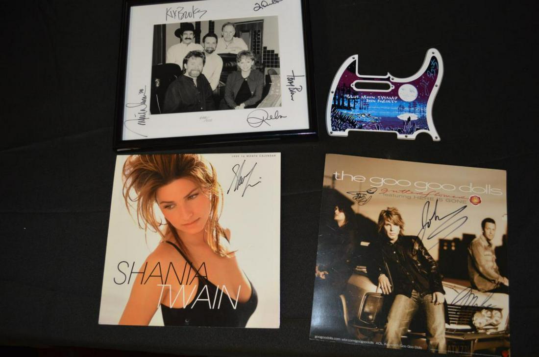 Four Pieces of Signed Music Memorabilia: Four Pieces of Signed Music Memorabilia. A pick guard signed by John Fogerty, 7 1/2"h., A promo card signed by the Goo Goo Dolls, 12 1/4"h., a 1999 calender of Shania Twain signed by her, 11 3/4"h. an
