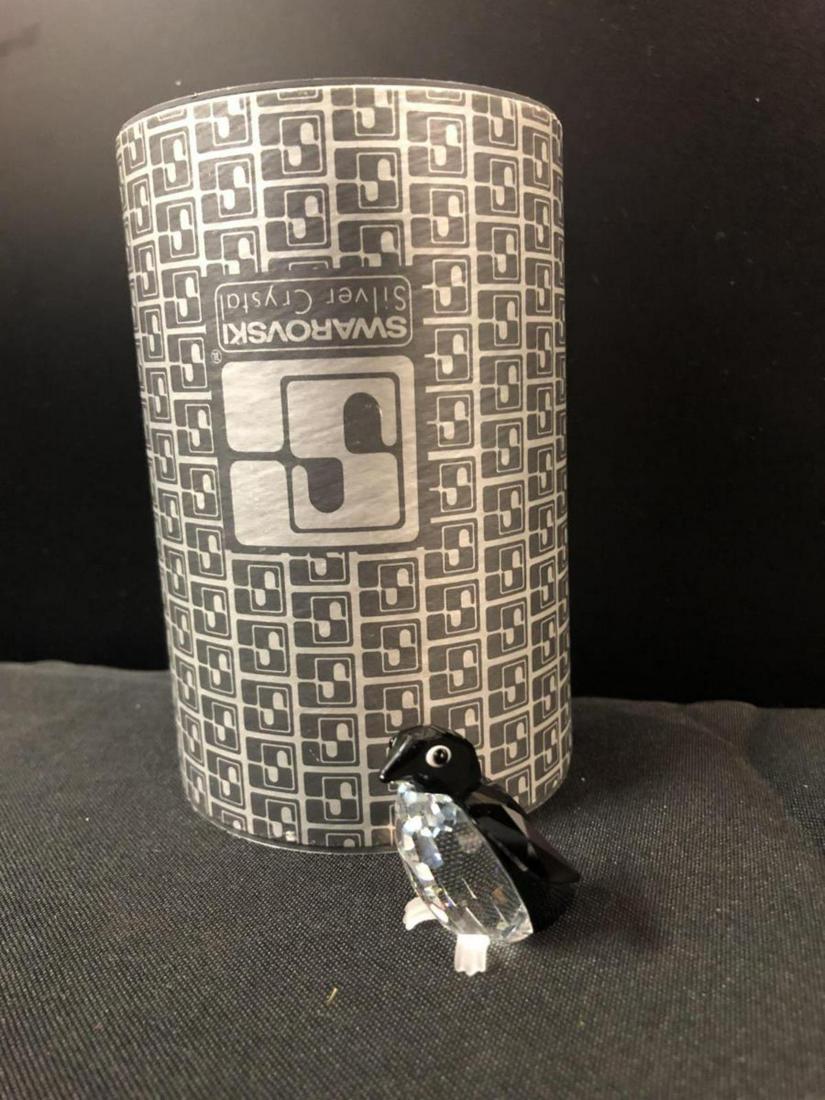 Swarovski Crystal Madame Penguin #7661 w/Tube: Swarovski Crystal Madame Penguin, #7661 with original tube. Classic quality collectible figurine for home & office decor. Excellent condition with original packing. Made in Austria.