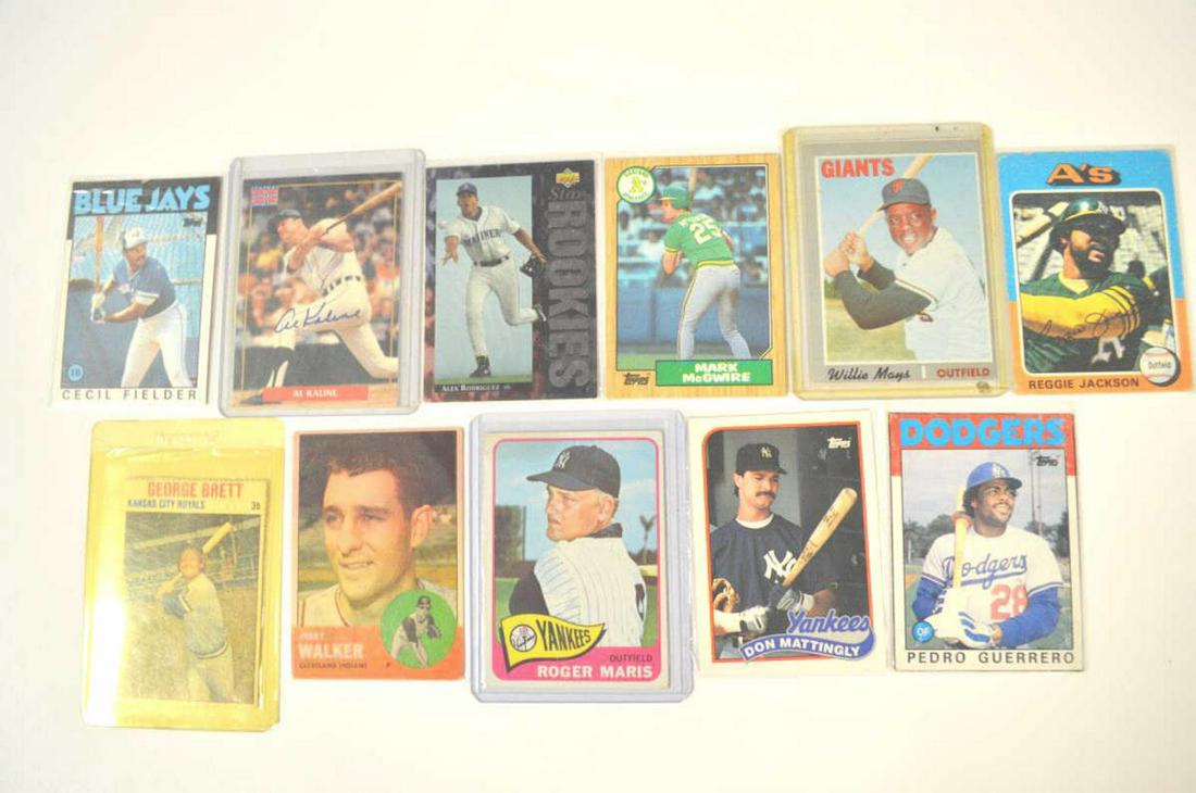 Lot Of Baseball Cards: Lot Of Baseball Cards. Total of 11 cards in the lot. Consists of Topps Mark McGwire, Topps Cecil Fielder, Topps Pedro Guerrero, Topps signed Reggie Jackson, Topps Don Mattingly, Topps Roger Maris, Top
