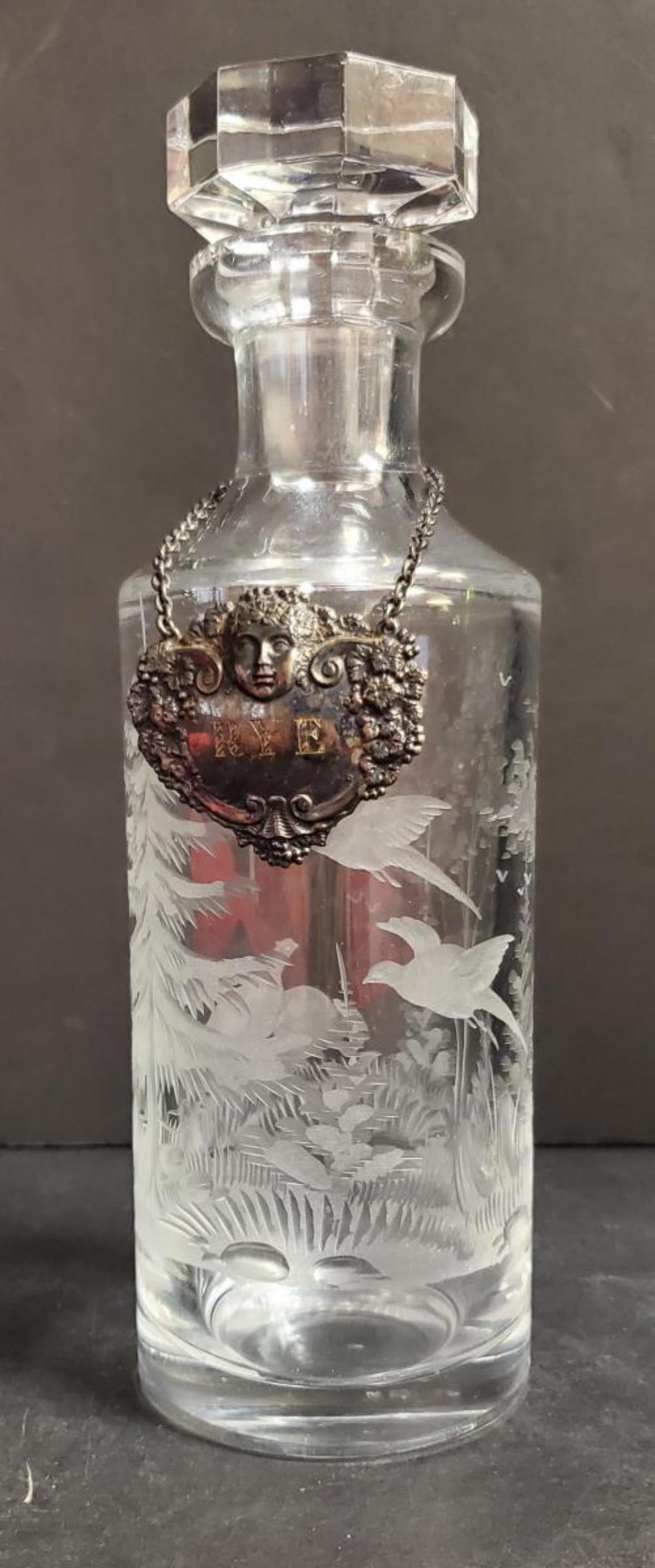 Crystal Decanter w/Stopper Pheasant Etched Scene: Crystal Decanter with Hex Stopper Pheasant Etched Forrest Scene. This great liquor decanter is very heavy & in great condition, it has an ornate silver plated name tag engraved "RYE". It is 10 3/4" ta