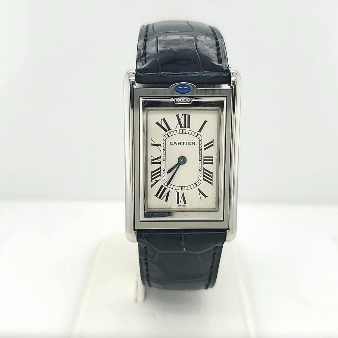 Ladies stainless Cartier Tank Basculante watch: Stainless steel Cartier Tank Basculante watch, ref# 2390, featuring a swiss quartz movement, textured cream color dial with roman numerals, sapphire crystal, and navy blue leather strap. Case measures